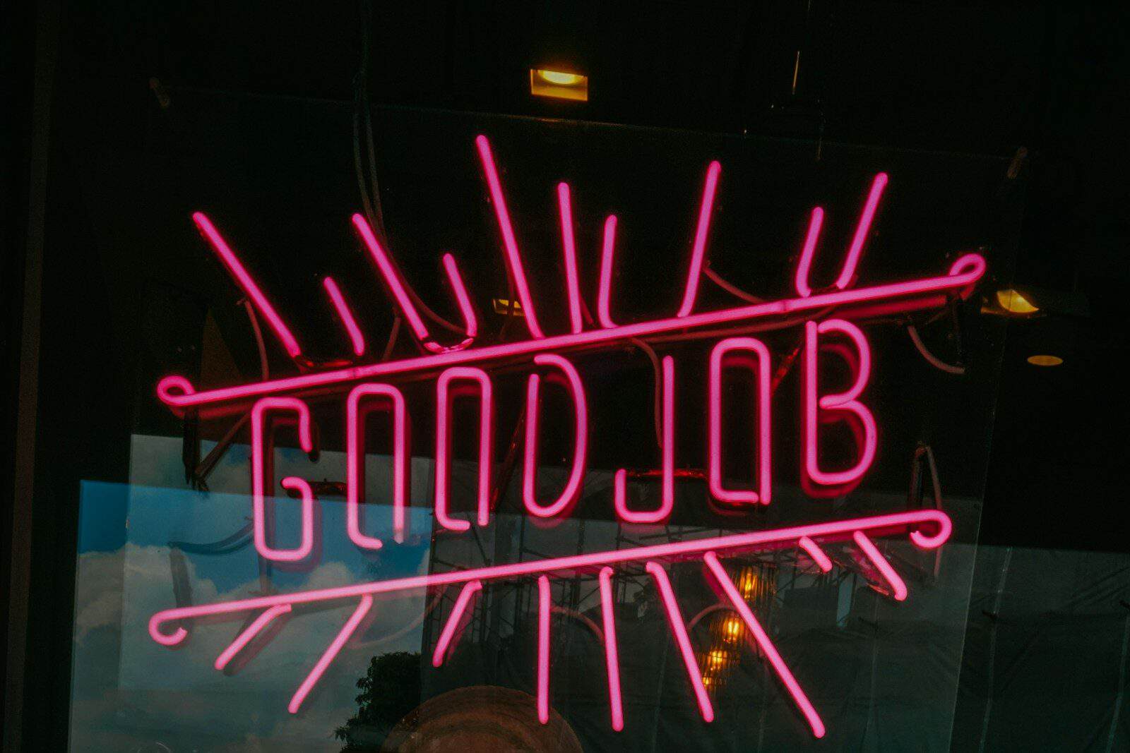 a neon sign that says goodjob on it