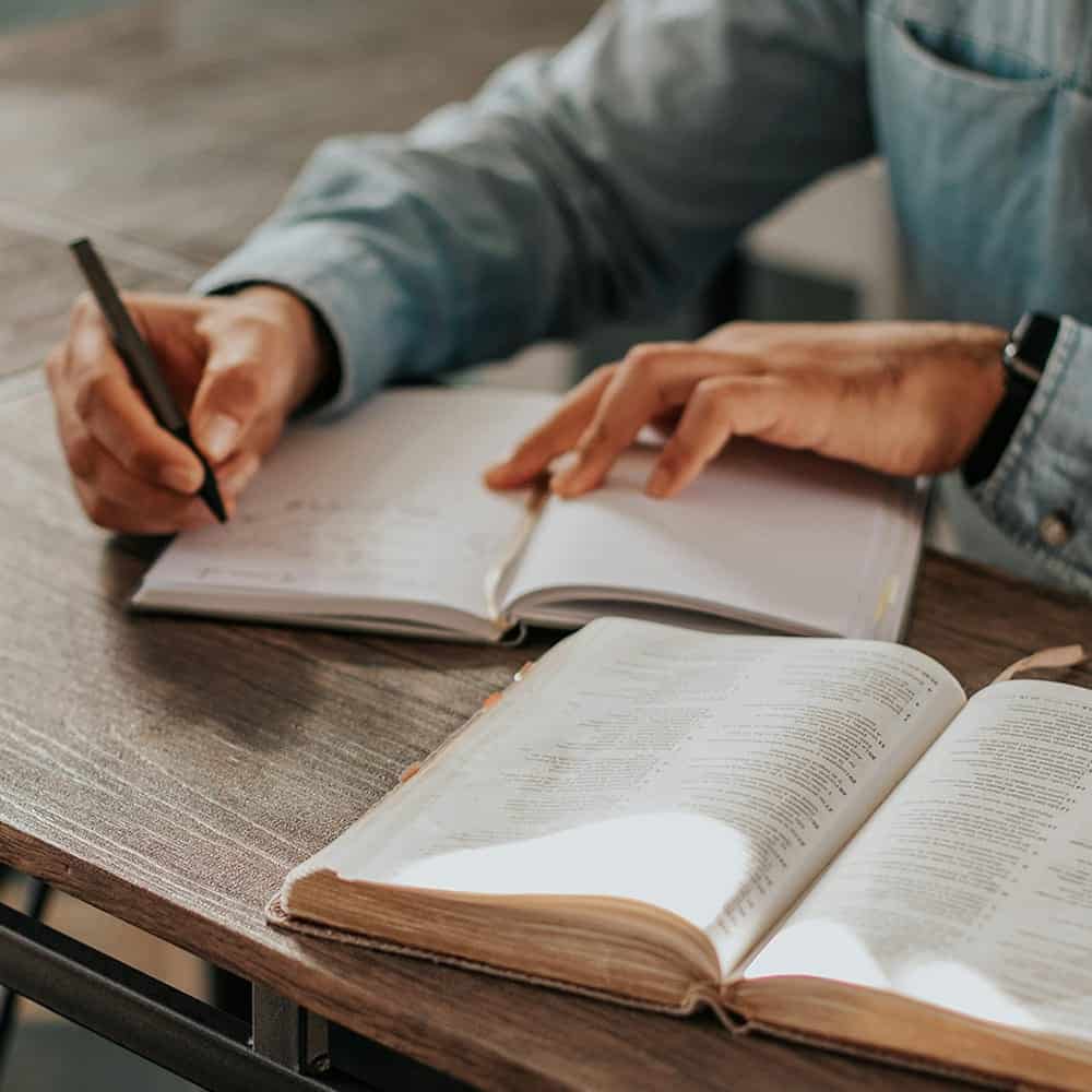 Leader reflecting and writing in a journal — resilience practice for executives